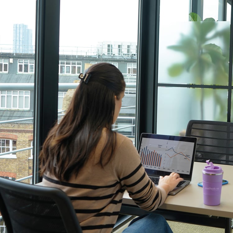 Decorative photo of a Methods employee working on a desk in the office